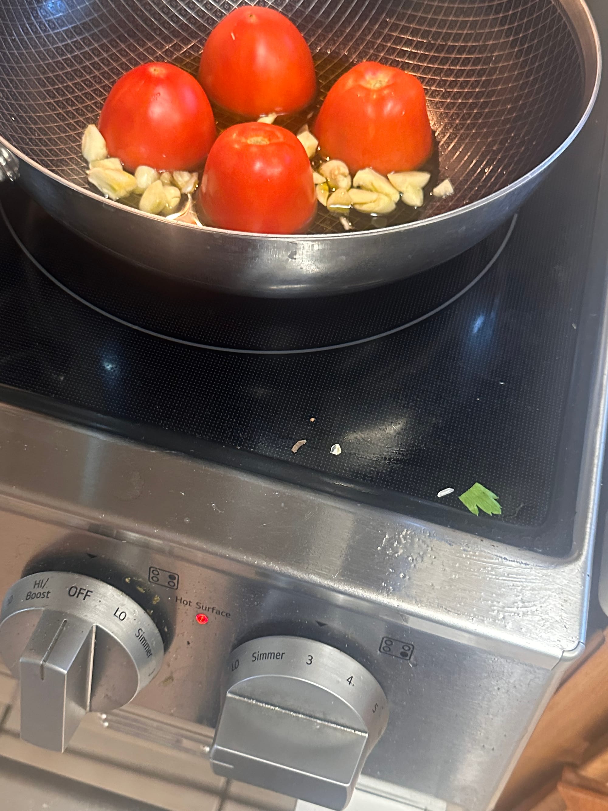 Bowl of cooked chickpea pasta seasoned with garlic, olive oil, and parmesan