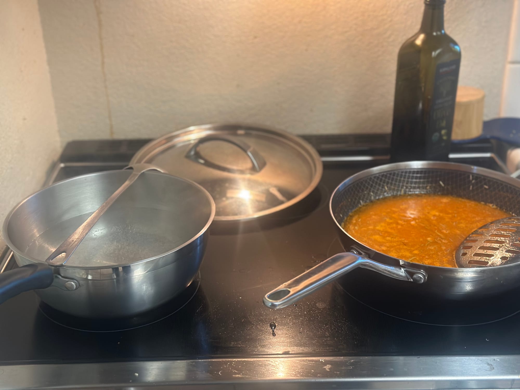 Bowl of cooked chickpea pasta seasoned with garlic, olive oil, and parmesan